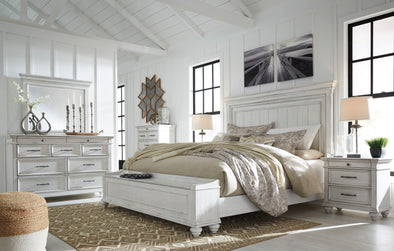 Sunny, wood based room with a Kanwyn Whitewash 5 Pc King Storage Bedroom Set